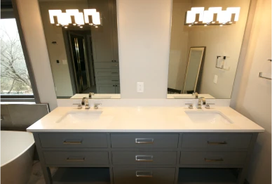 Modern bathroom with double sink vanity and mirrors.