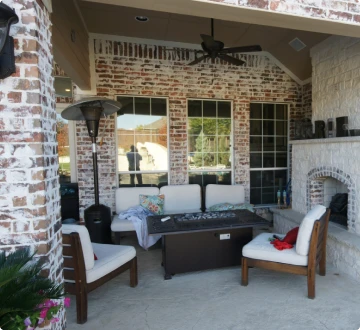 Outdoor patio with seating and fireplace