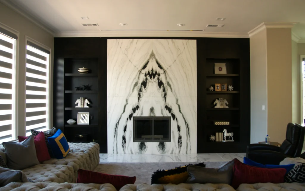 Modern living room with marble fireplace wall.
