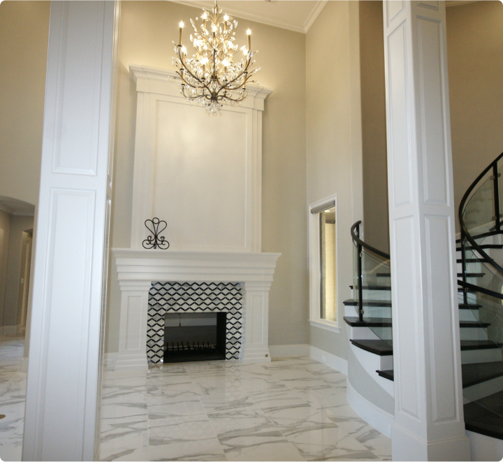 Elegant foyer with marble floors and chandelier.