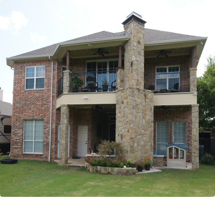 Two-story brick house with stone chimney