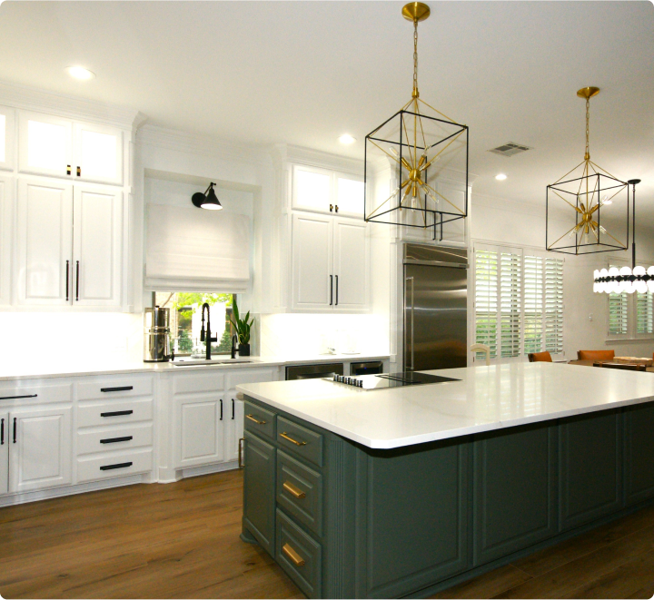 Modern kitchen with white cabinets and island.