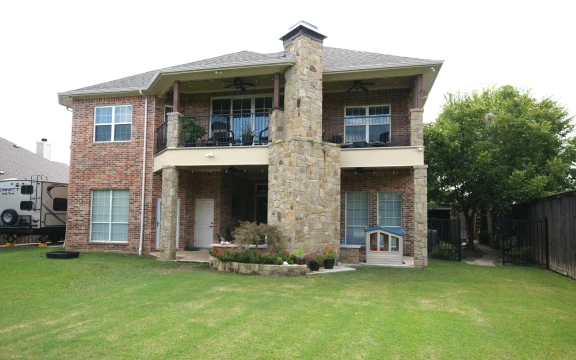 Two-story brick house with spacious backyard.