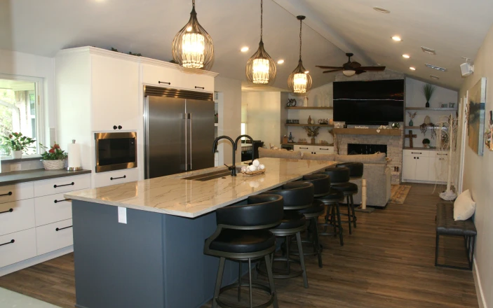 Modern kitchen with island and pendant lights.