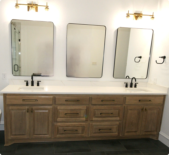 Modern bathroom with dual sinks and mirrors.