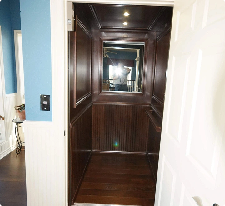 Wood paneled residential elevator interior view