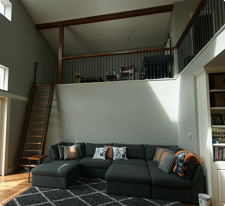 Modern living room with loft and gray sectional sofa.