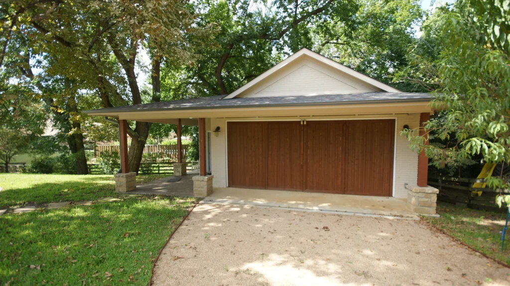 Wooden garage nestled among trees