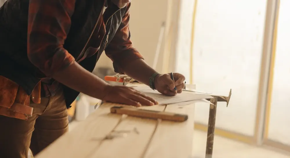 Construction expert marking blueprints