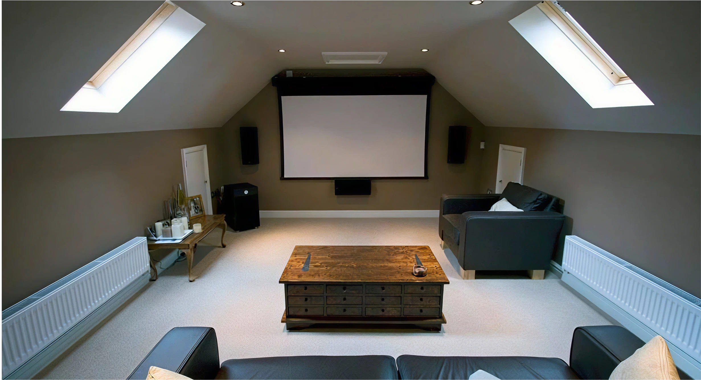 Home movie theatre. View from a couch facing a white screen.