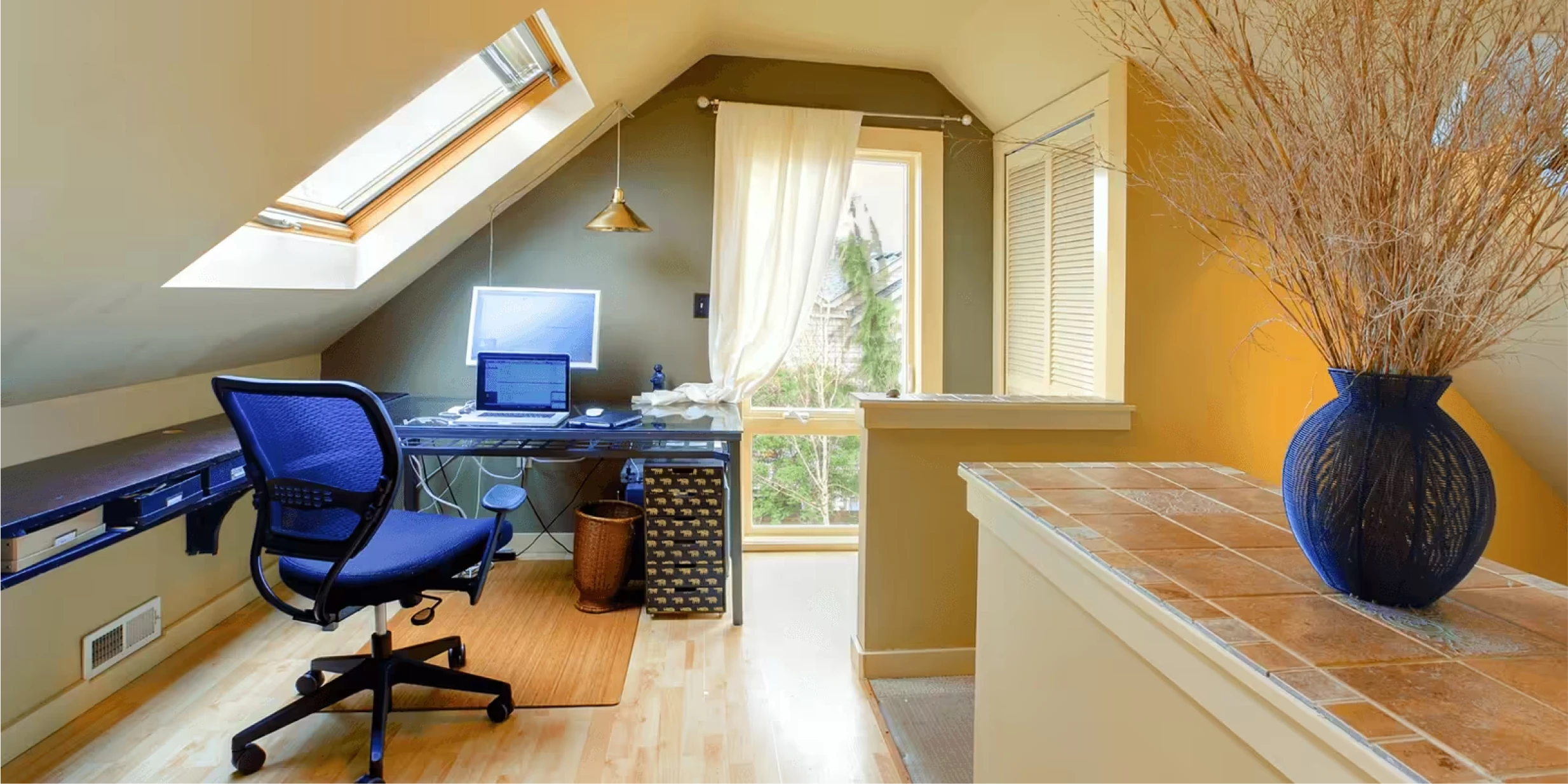 Office space in a home with blue chair and blue decorations with white walls