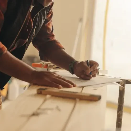 Construction expert marking blueprints