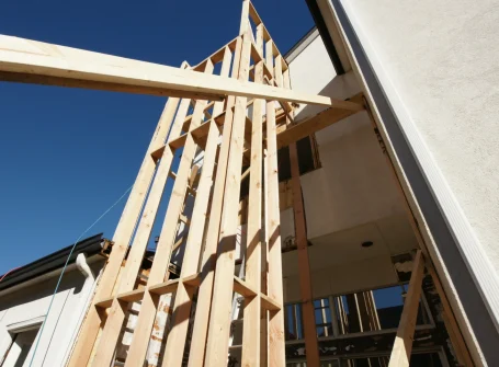 Wooden house frame construction in progress