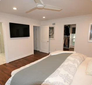 Modern bedroom with TV and closet view.